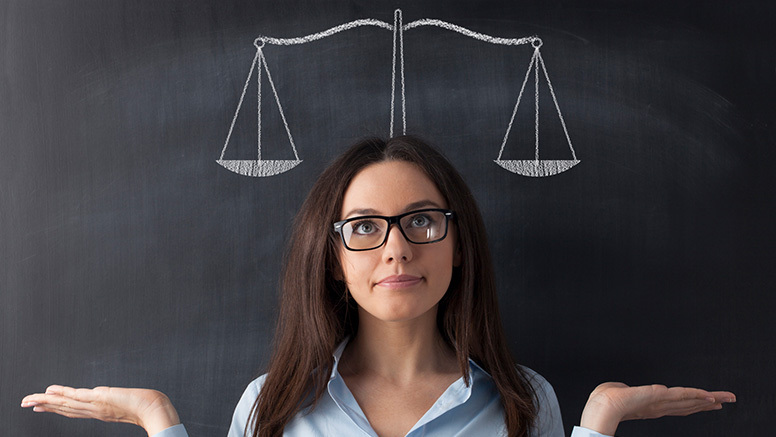 woman with glasses deciding between above graduation loan and staying in their program