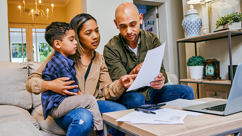 Family of three looking at their finances