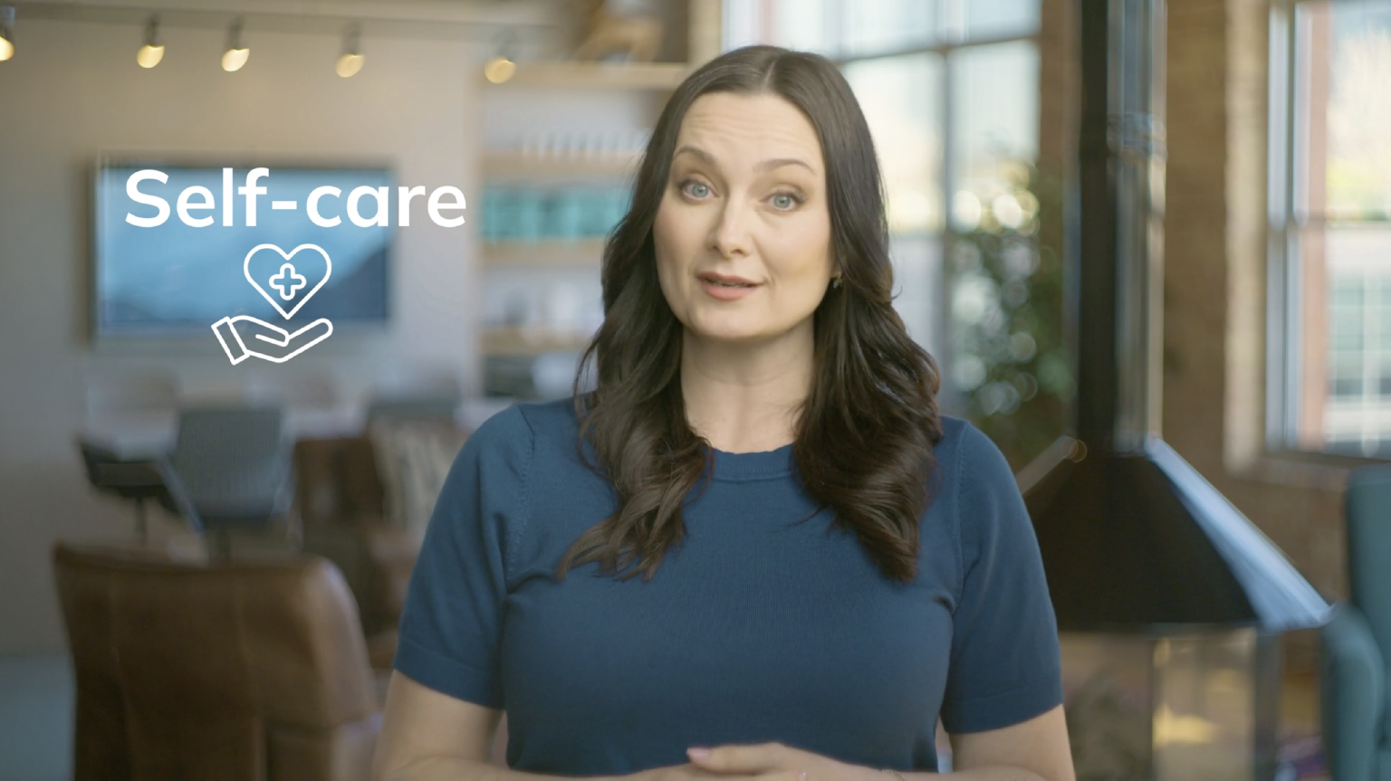 Beyond Finance’s chief financial wellness officer and financial therapist, Dr. Erika, appears next to the text "self-care" and a self-care icon
