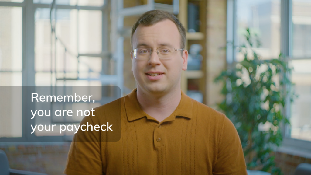 Screengrab of Nathan Astle from video with the words "Remember, you are not your paycheck" overlayed