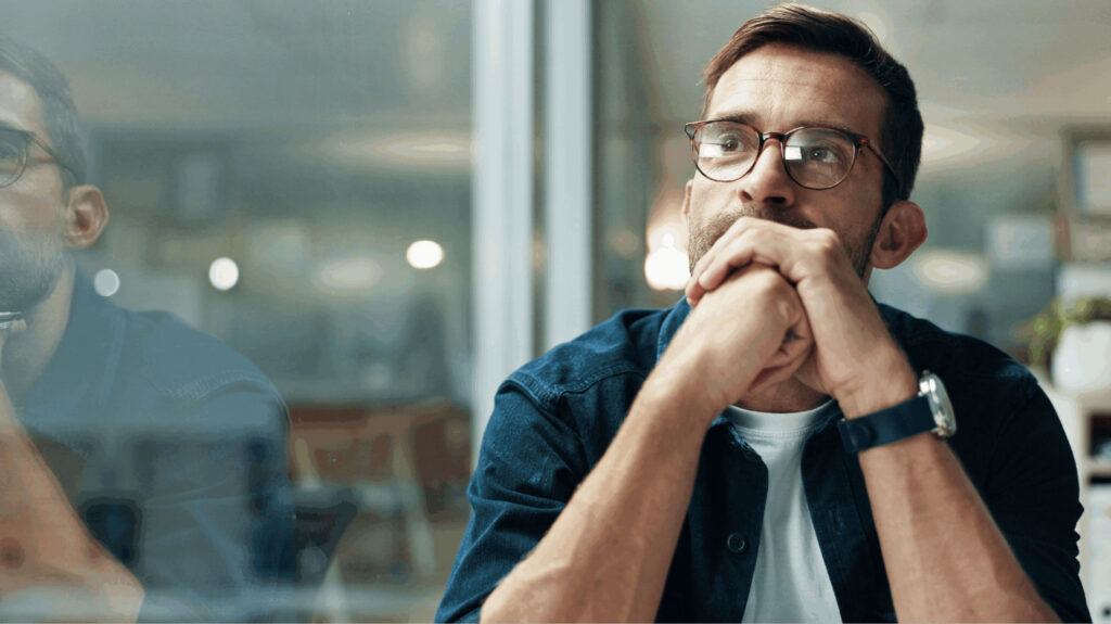 Man thinking, working on healing negative thoguht patterns about money