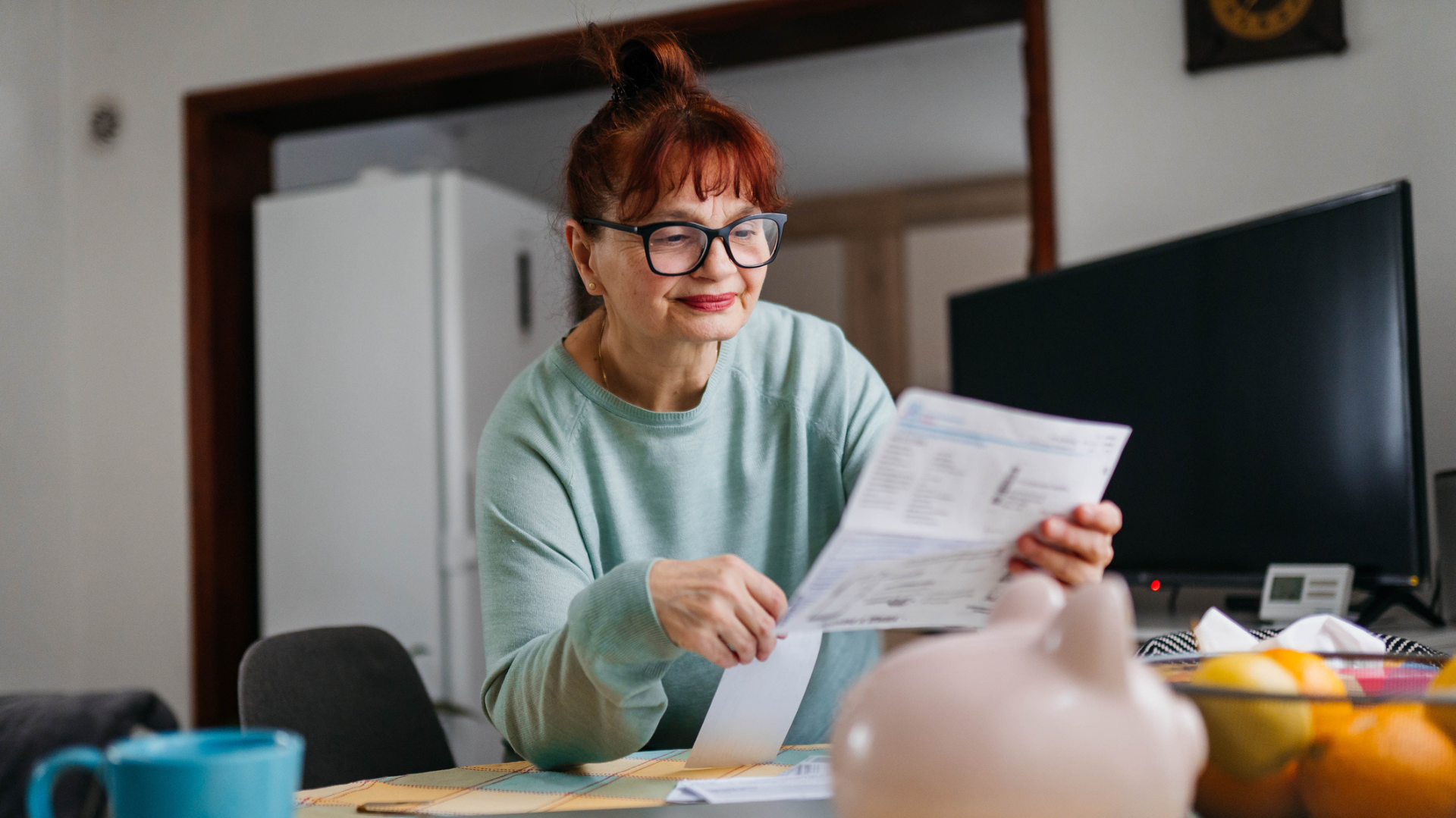An older woman examines her financial documents