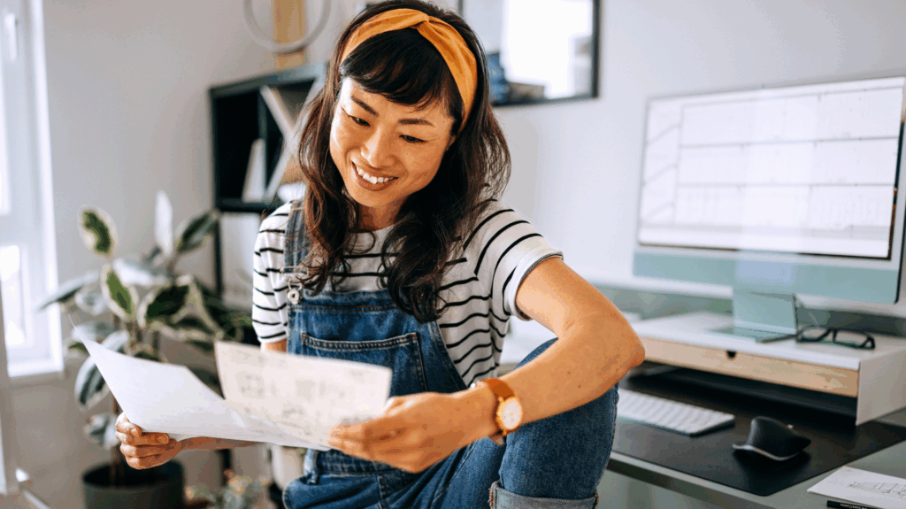 Woman smiles at paperwork