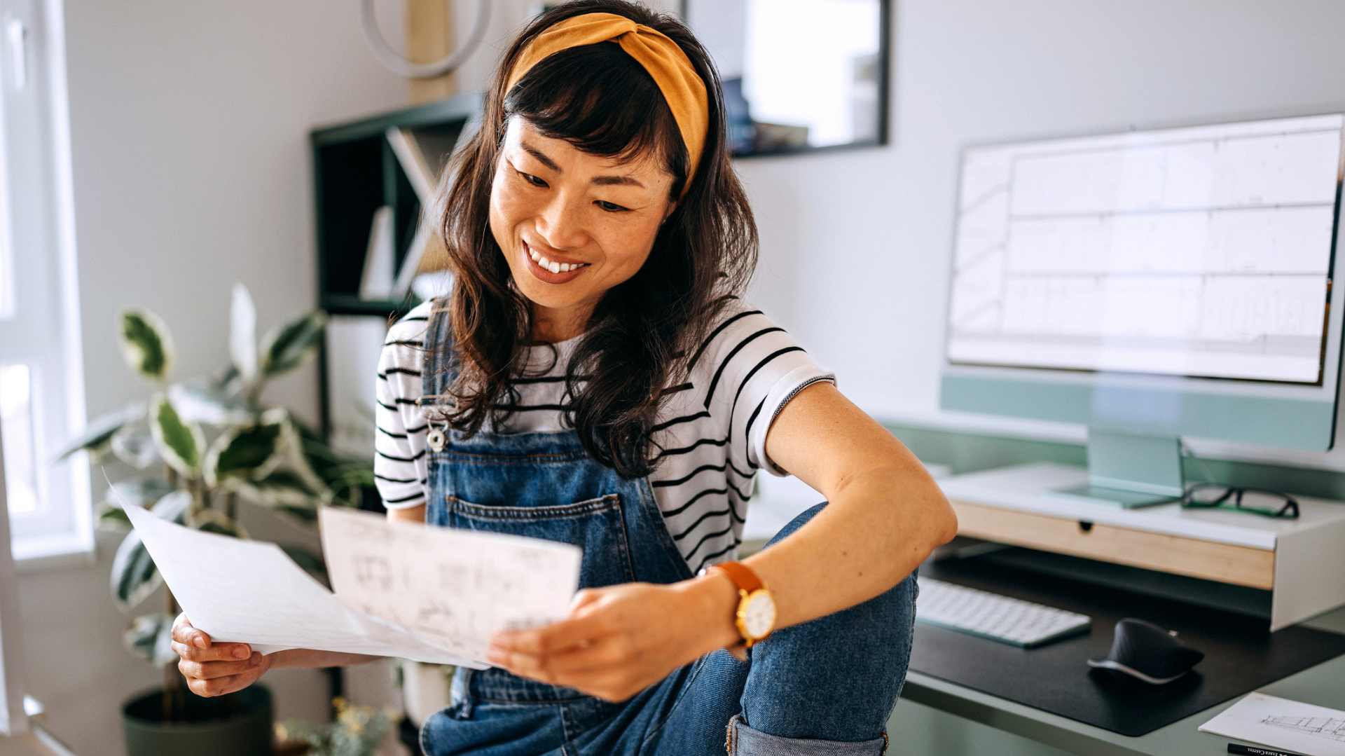 Woman smiles at paperwork