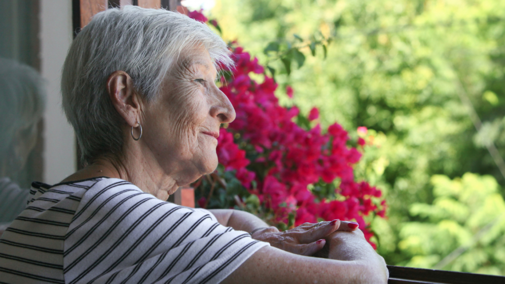 Picture of a woman staring hopefully out the window