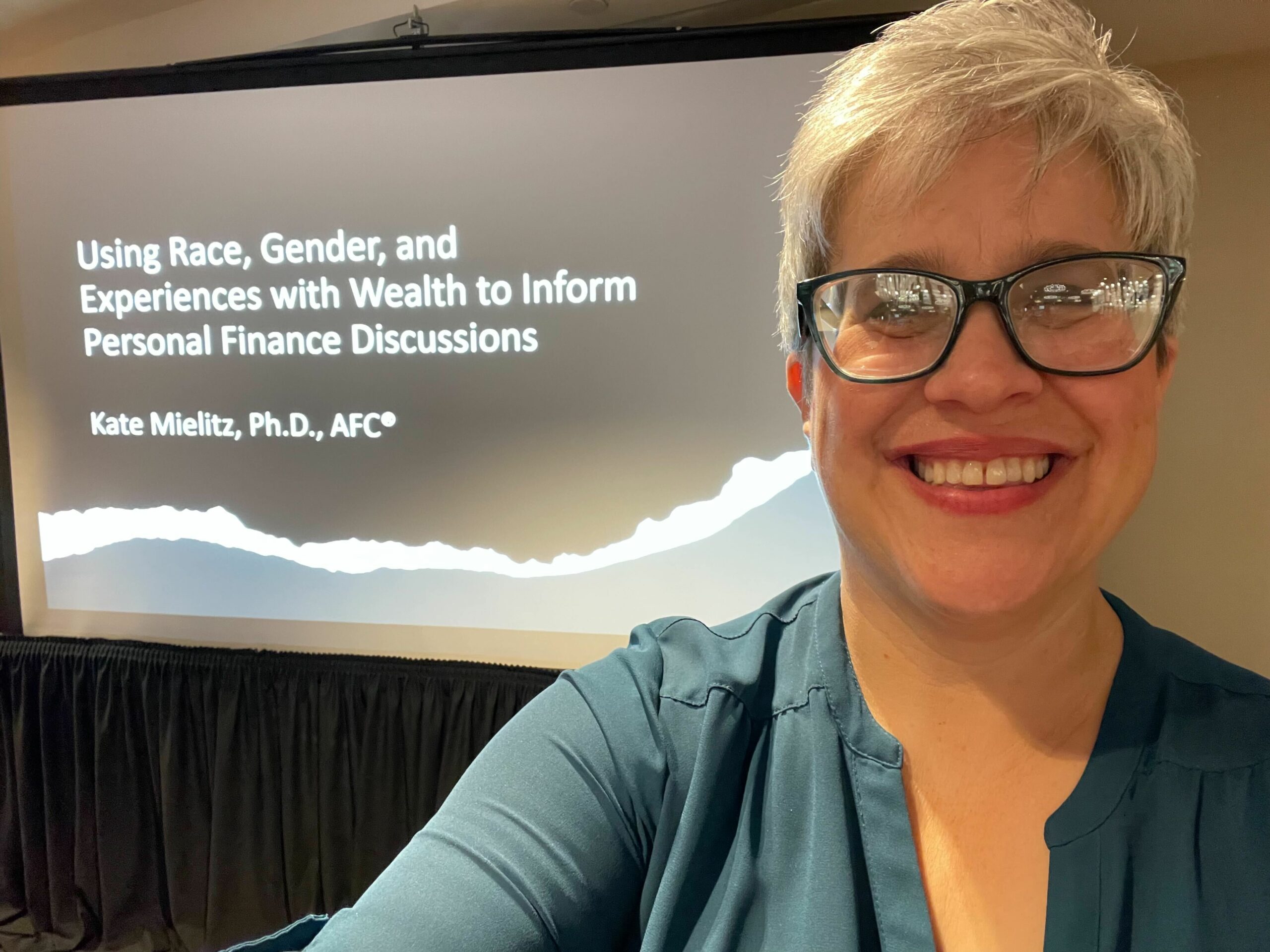 Dr. Kate Mielitz at a conference. Welcome her to Beyond Finance.