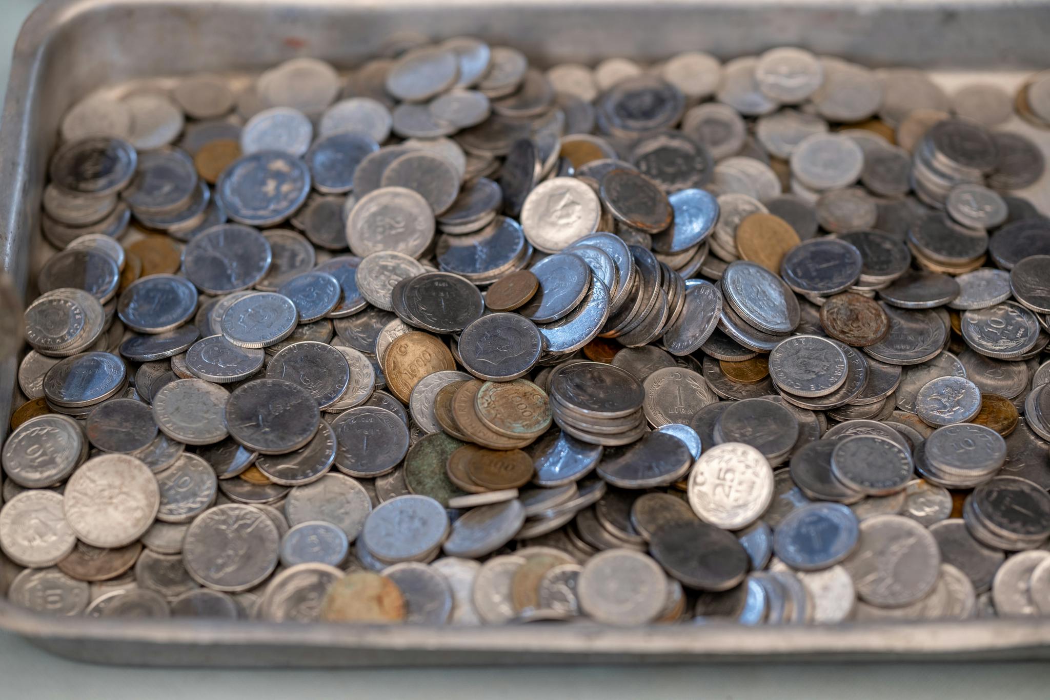 A tray full of coins on a table
